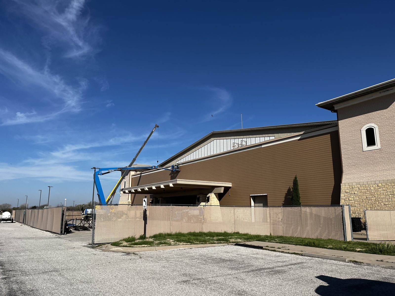 Commercial exterior siding work with boom lift